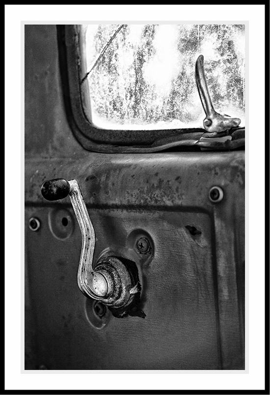 Car door window handle in black and white.